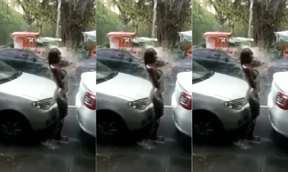 Bold woman strips down and take a cold shower in the street in broad daylight