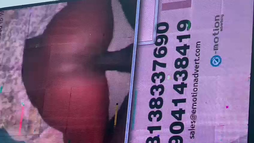 A digital billboard in CBD shows hardcore porn