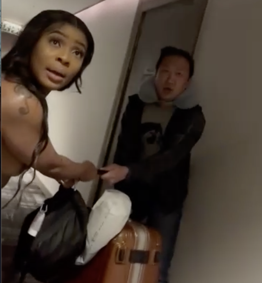 Naked Escort demands her payment from an Asian man in a hotel lobby